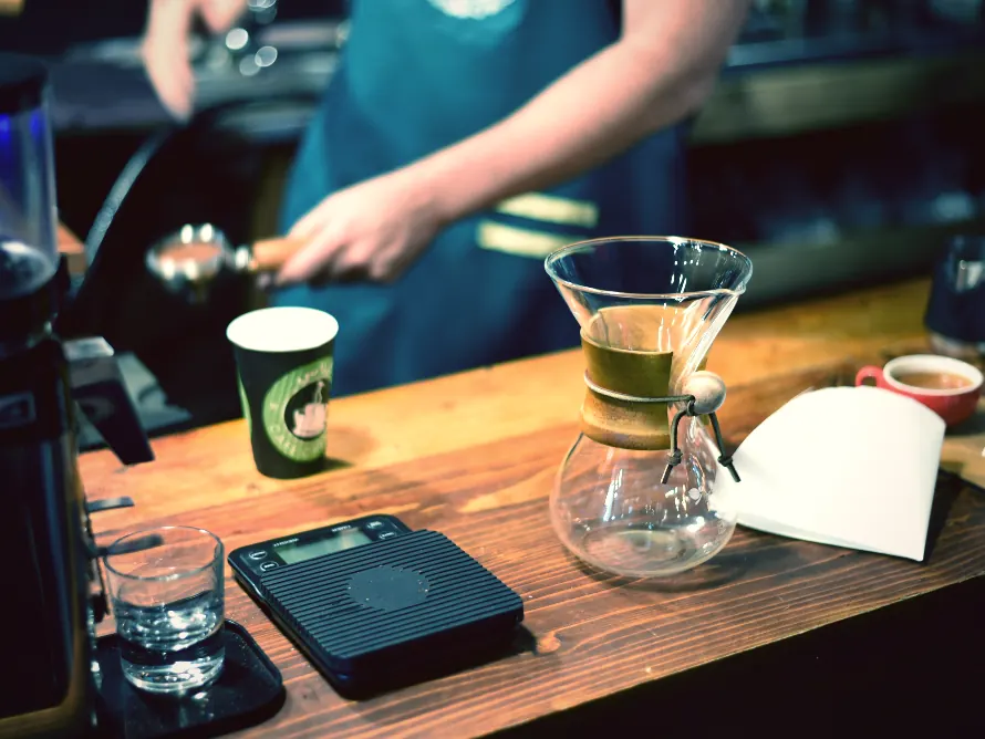 A barista pouring at a coffee bar, filmed for a second site opening