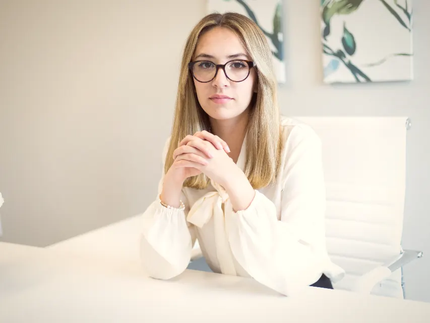 A consultancy founder at her desk, photographed for the website rewrite