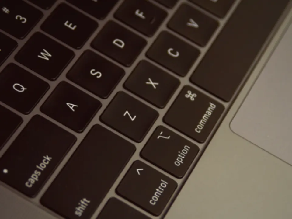 A laptop keyboard in low light, where the copy gets written